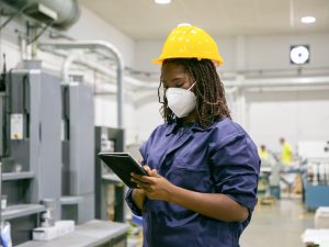 female-factory-worker-mask-holding-tablet