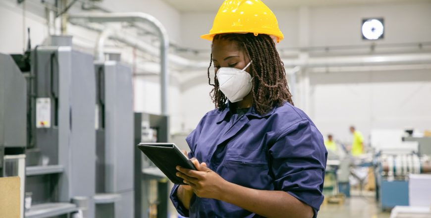 female-factory-worker-mask-holding-tablet