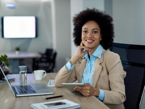 happy-african-american-businesswoman-working-touchpad-office